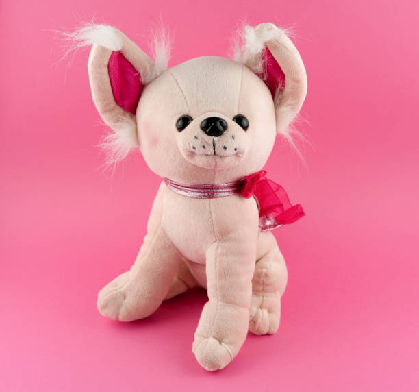 istock Cute chihuahua plush dog on a pink background 1373304985