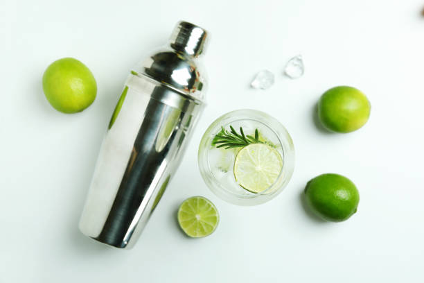 istock Glass of cocktail with lime and ingredients on white background 1373307329