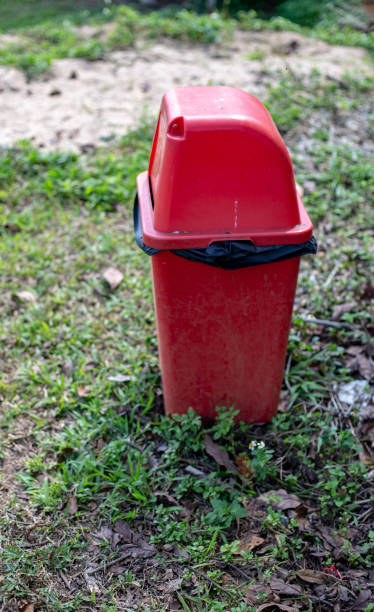 istock Red bin in the park and blurred background. 1373307546