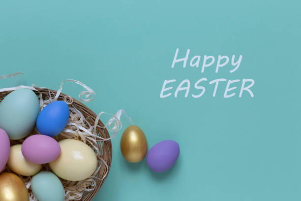 istock Easter background with colorful eggs in a basket on a blue background. Top view with copy space 1373307772