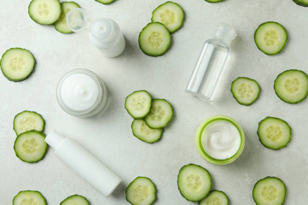 istock Cosmetics and cucumber slices on white textured background 1373312787