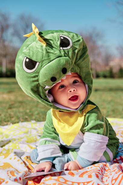 istock Baby dressed in a dinosaur costume 1373319529