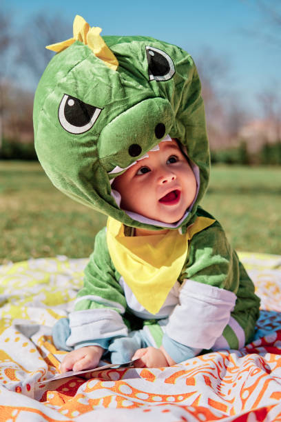 istock Baby dressed in a dinosaur costume 1373319776