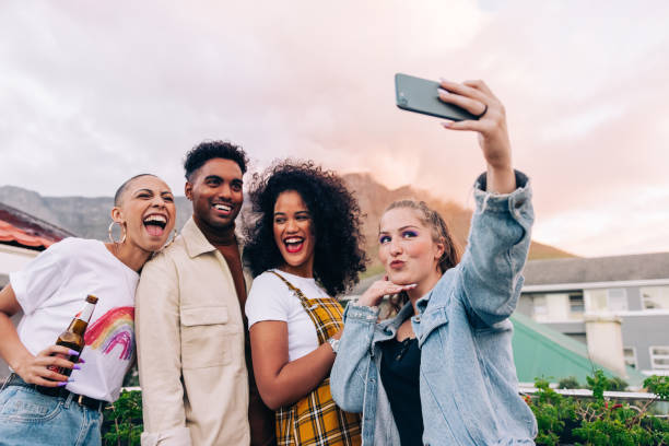 istock Friends taking a group selfie outdoors 1373330444