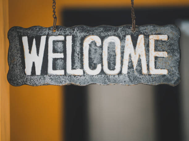 istock Welcome sign written on blackboard hanging on vintage wall. 1373332007