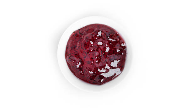 istock Jam in a gravy boat isolated on a white background. Purple jam 1373344845