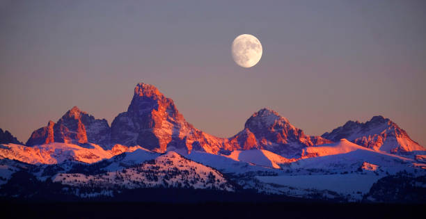 istock Sunset Light Alpen Glow on Tetons Teton Mountains wtih Moon Rising 1373346188