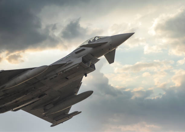RAF Typhoon NATO QRA response fighter jet leaving for Europe 12.2.2022 - Sky over Coningsby Lincolnshire RAF QRA NATO rapid response Typhoon jet fighter plane supporting air defence operations in Europe typhoon stock pictures, royalty-free photos & images