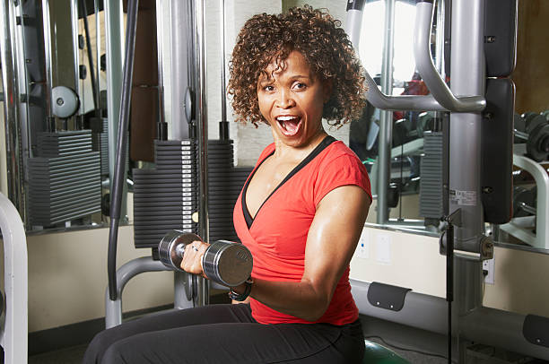 Mujer ejercicio en el gimnasio con pesas - foto de stock