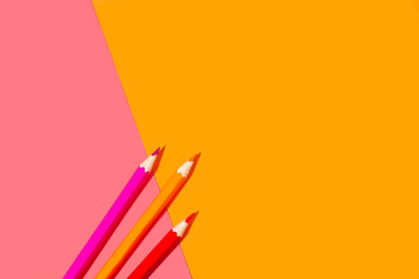 istock Orange and pink pencils on a pink and orange background 1373358565