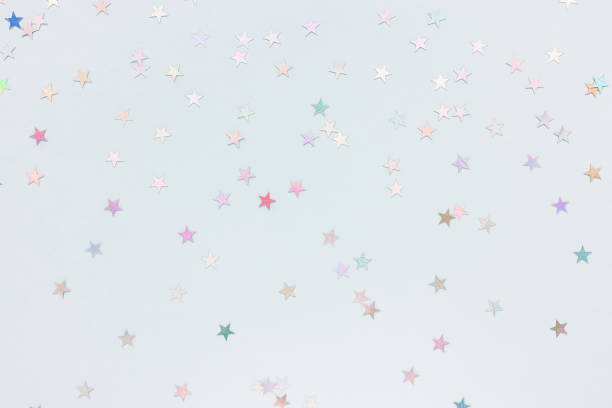 istock Silver foil confetti stars on blue background 1373366609