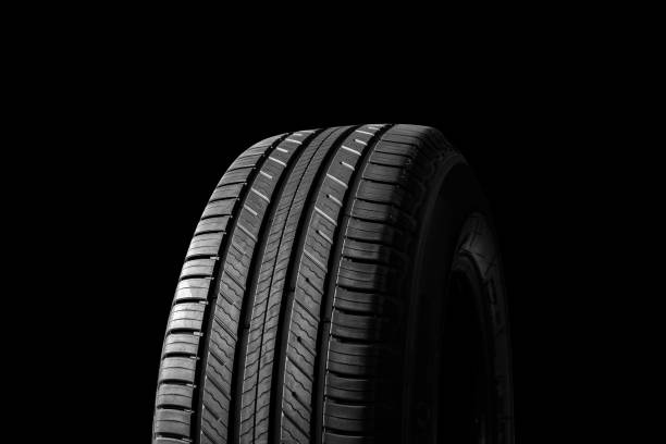 istock A new tire is placed on black background. 1373369130
