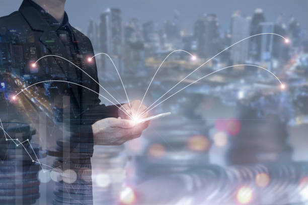 istock Double exposure of businessman using smart phone with blurred night cityscape and network connection. Demonstrates the use of technology to connect businesses around the world. 1373369662
