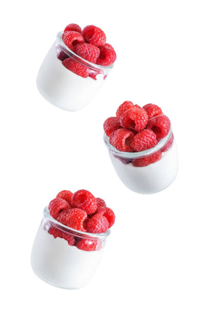 istock Greek yogurt with raspberry in a glass on a white isolated background 1373374433