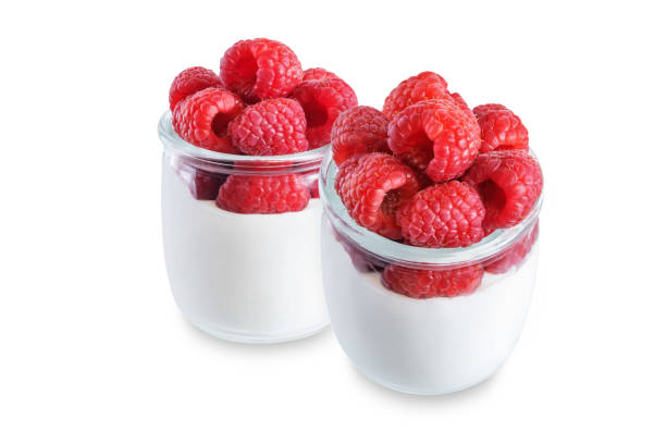 istock Greek yogurt with raspberry in a glass on a white isolated background 1373374434