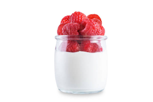 istock Greek yogurt with raspberry in a glass on a white isolated background 1373374435