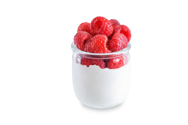 istock Greek yogurt with raspberry in a glass on a white isolated background 1373374437