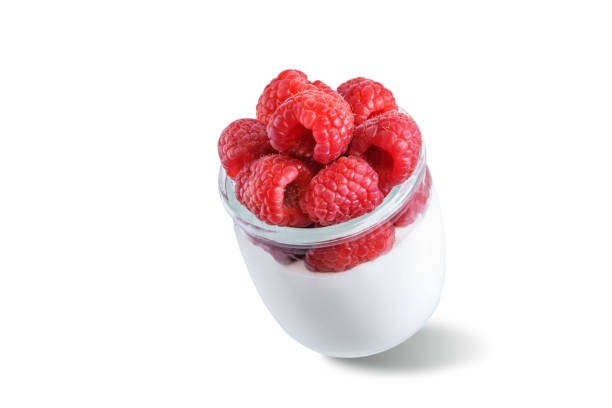 istock Greek yogurt with raspberry in a glass on a white isolated background 1373374443