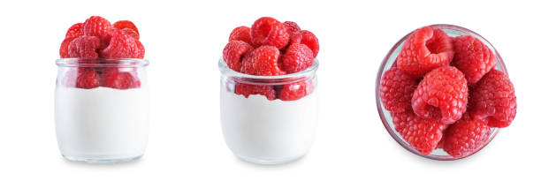 istock Greek yogurt with raspberry in a glass on a white isolated background 1373374449