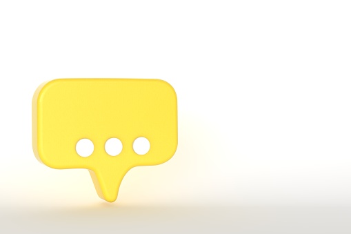 White comment sign on yellow speech bubble