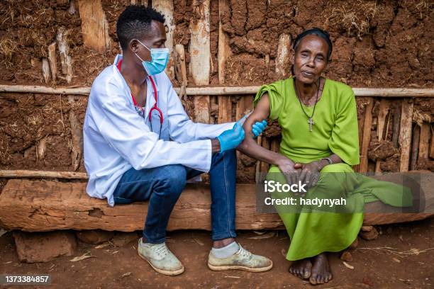 Doctor Is Doing An Injection To Senior African Woman In Small Village East Africa Stock Photo - Download Image Now