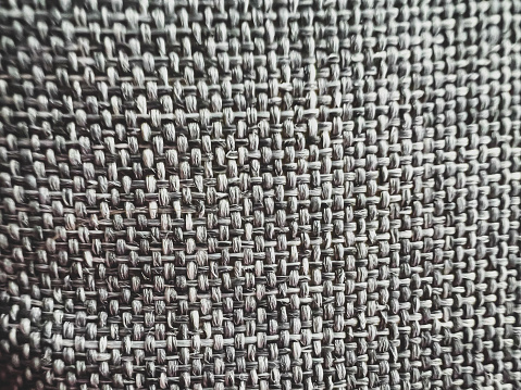 Close-up of a beautiful gray white fabric.