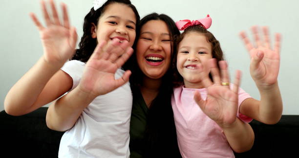 istock Mother and children waving goodbye with hands 1373395108