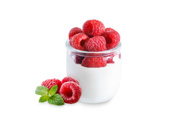 istock Greek yogurt with raspberry in a glass on a white isolated background 1373401602