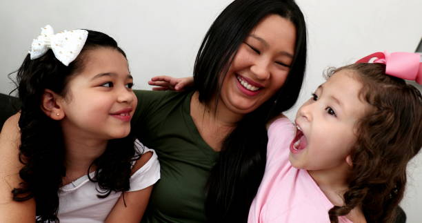 Mother and children together in home sofa