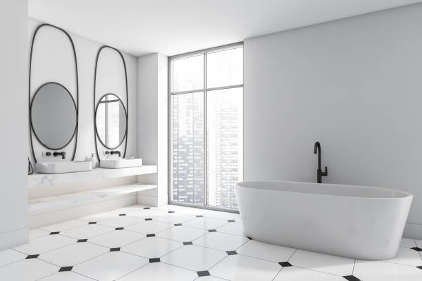 istock Corner view on bright bathroom interior with bathtub, two mirrors 1373414321