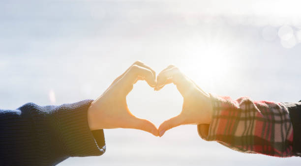 istock Man and woman form a heart with their hands 1373430233