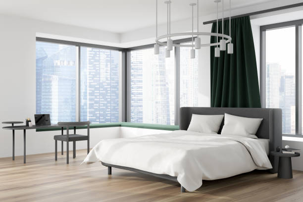 istock Modern bedroom interior with bed and workplace, panoramic window with city view 1373431891