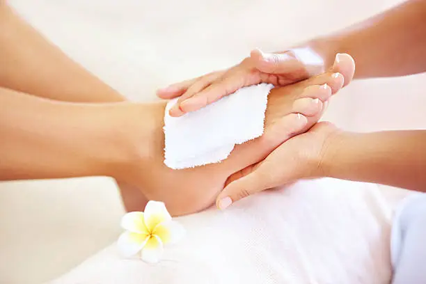 Beautician giving a client a relaxing foot massage