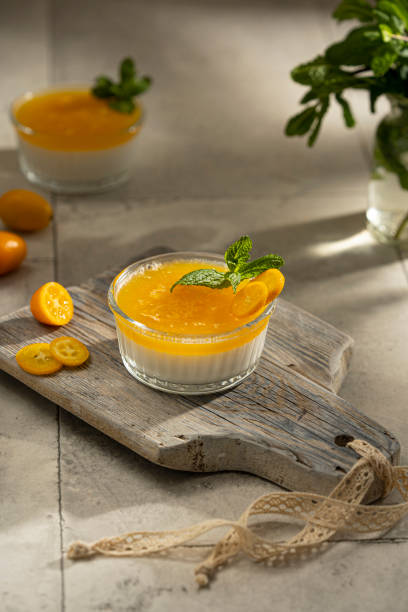 istock Orange Panna Cotta, a Creamy Italian Pudding with a tropical fruit Gelatin Layer and mint 1373452996