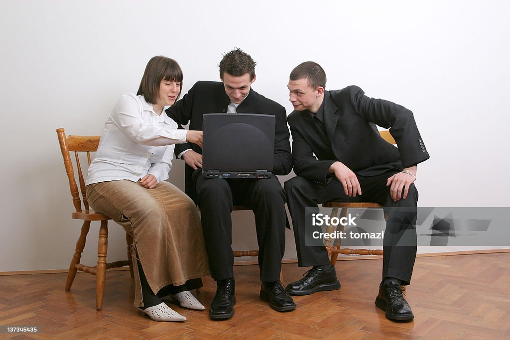 Learning together Three people interested in notebook computer. Adult Stock Photo