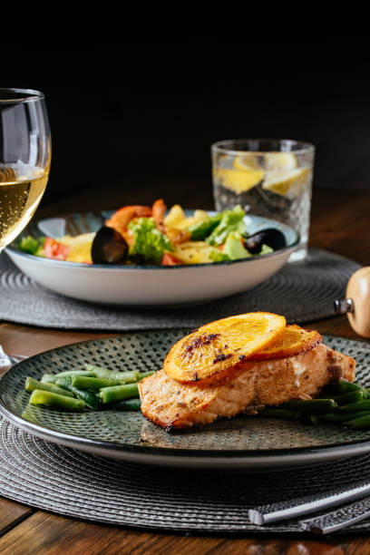 istock grilled fish with a side dish on a wooden background. Restaurant 1373464476