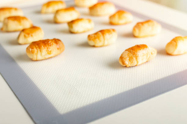 Fresh sweet dessert pastries on a baking mat with copy space.