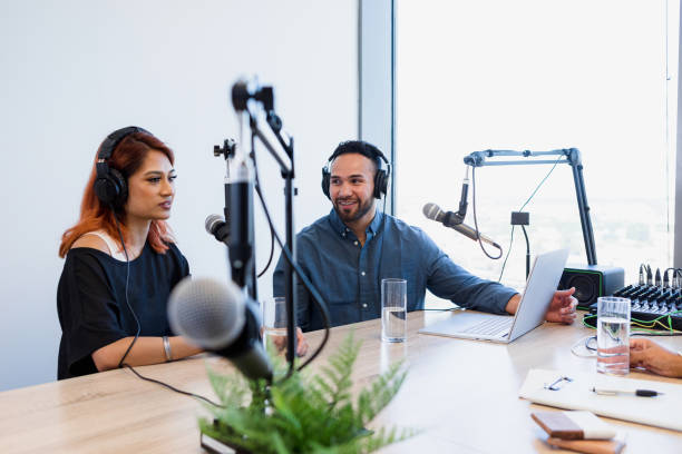 istock Man looks at female co-host during guest interview 1373466106