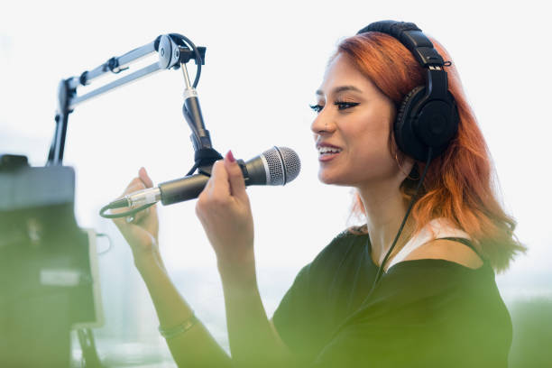 istock Young adult woman records performance in studio 1373466125