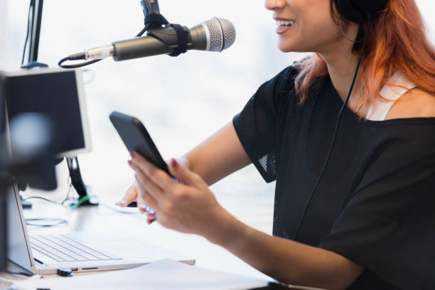 istock Unrecognizable female podcaster uses phone, laptop, and tablet 1373466127