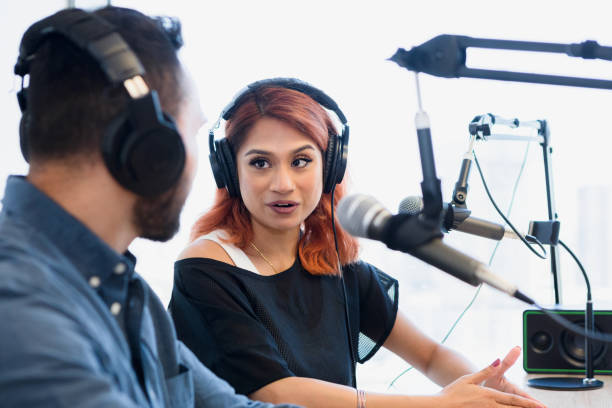 istock Podcast co-hosts record show in studio 1373466139