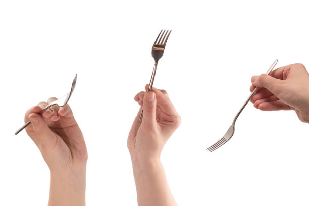 Fork in woman hand isolated on white.