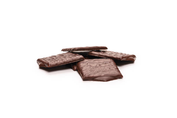 istock Dark chocolate candies isolated on white background. 1373475175