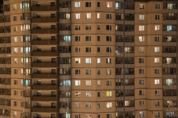 illuminated windows of an apartment building