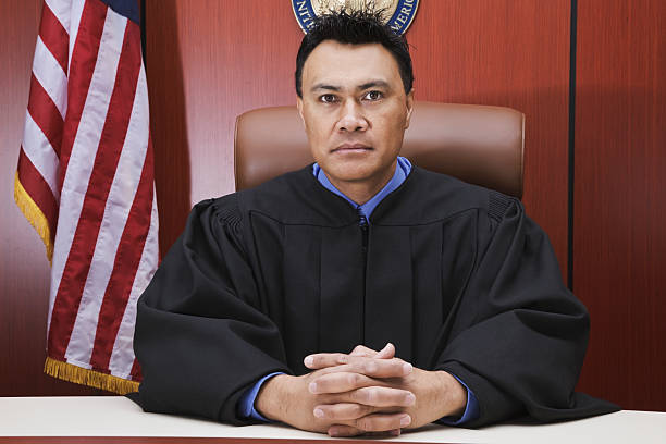 Serious Male Judge in Courtroom stock photo