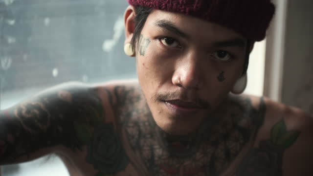 Young Asian man with tattoo on body