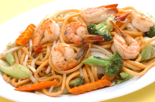 A plate of spaghetti aglio olio served with shrimps.