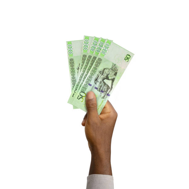 istock Black Hand holding 3D rendered 50 Libyan dinar notes isolated on white background 1373515520