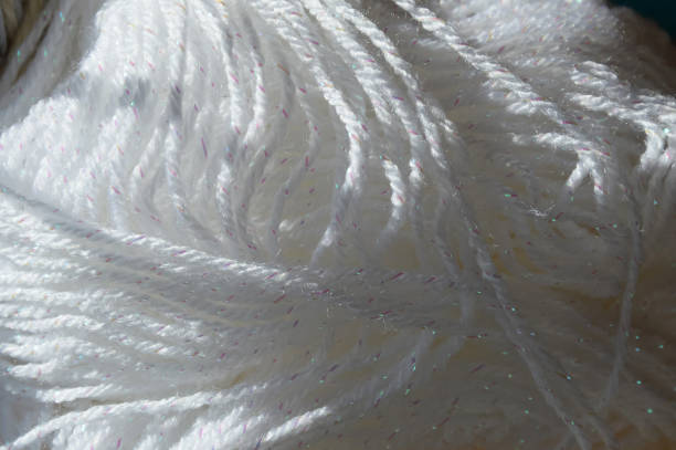istock knitting day. white skein of woolen thread needlework. background for the design. 1373522979