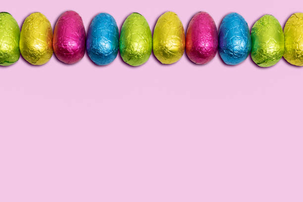istock Easter eggs in colorful foil on pink background. 1373526646